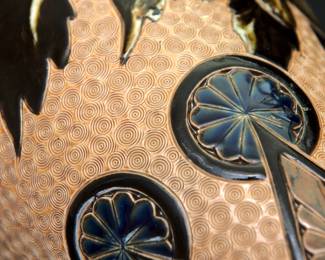 Closeup of the massive antique Royal Doulton Lambeth stoneware baluster vase, 18-1/2 inches tall. Decorated with a graceful spray of flowers over a textured pale amber ground between a band of deep blue and brown lappets and roundels at the shoulder and points with roundels at the foot, a collar of white beaded overlapping blue roundels on the neck, two bands of white beading above the foot. Base with impressed Doulton Lambeth mark, artist's marks, and model numbers. Late 19th century.