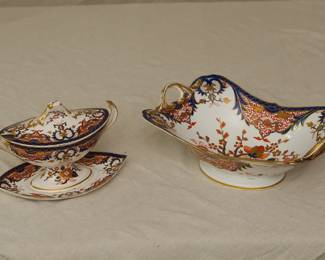 View of the Crown Derby porcelain lidded sauceboat with stand, and fruit stand of footed rectangular shape with two foliate scroll handles that are marked for Crown Derby, Imari, "Kings" pattern,  circa 1806-1825. 