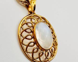 Closeup of 18k yellow gold and cabochon moonstone pendant necklace, made in Italy