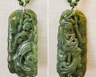 Closeup of the gorgeous beaded jade and carved jade pendant necklace with 14k yellow gold clasp, the pendant carved to show a phoenix bird amidst bamboo 