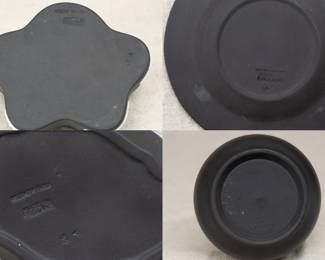 View of the bases of the View of the group of five Wedgwood black jasper ware pieces including a vase and a lidded trinket box