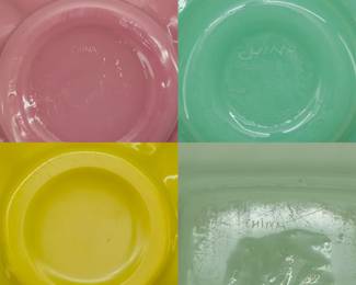 Closeup of Peking Glass bowls and cache pots in a variety of colors, several have the word "CHINA' hand etched on the base.