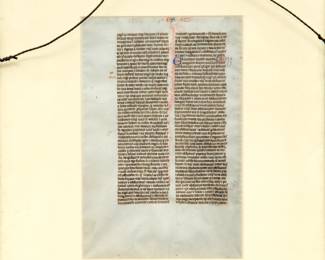 Reverse view of the framed page from The Biblia Sacra Latina, a Latin Bible produced by the “Alexander atelier” in Paris, between 1220-1230. The page from the Latin Bible (21.2 x 14.5 cm) written in brown ink in a neat, highly compressed quadratus Gothic bookhand in 49 double-columned lines per side on thin, smooth, cream-colored vellum. Book of Ezra aka Nehemiah. Recto: page heading “DRE” Verso: page heading “ES”