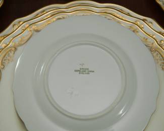 Closeup of Spode Copeland's China service for four in fine bone china, white with gold gilt scrollwork edges 