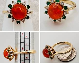 A very fiery fire opal set in 14-karat yellow gold encircled by emeralds and diamonds -- the pictures do not capture the amazing fire in this stone!