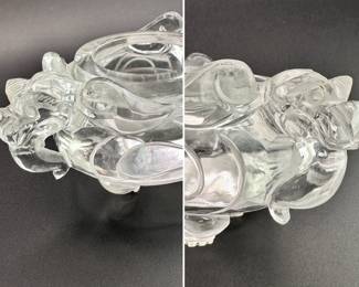 Closeups of the handles on the Chinese carved rock crystal censer and cover, early 20th century, of compressed globular form, resting on three short paw-shaped feet, the lid surmounted with a seated mythical beast, shoulders are flanked by mythical beast mask handles. Both the lid and body are carved with taotie mask designs.