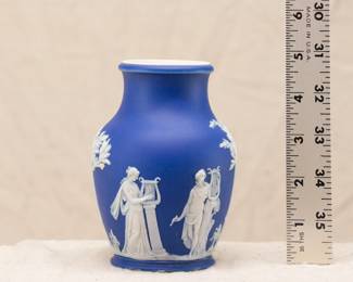 A small, Wedgwood, blue dip jasperware vase, decorated with in white relief with classical figures