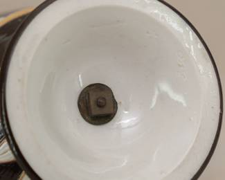 Closeup of the base of the antique 1850's Wedgwood black dip jasper ware double handled urn shaped vase with applied classical figures in white relief depicting the muses of comedy/drama, music, poetry; covered overall in a shiny clear glaze and with applied gilding. Wedgwood stamp to the base along with group of 4 "mustache" marks, and hand-incised numerals 350.  See example in of this vase in the Nelson Provincial Museum, Australia.