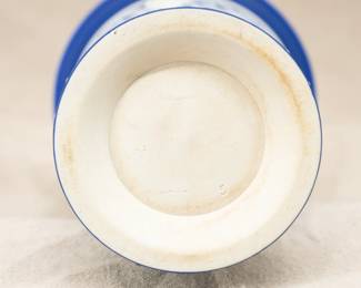 Closeup of the stunning and rare antique Wedgewood tri-color blue jasper dip with sage green cameo "Monopodia" vase, early 1900s.  Featuring architectural elements, not pictorial reliefs, the monopodia are used here as columns topped by a lion mask and terminated at the bottom by a single paw foot. A small oval sage green and white cameo adorns the side above a swag element and below a masterfully applied ribbon and vine border; acanthus leaves decorate the rim and the base.