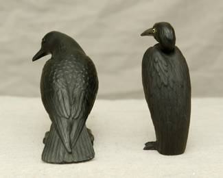 Another view of the Wedgwood black basalt model of a blackbird circa 1920 modeled by Ernest Light, with applied glass eyes, finely modeled details to the feathers, standing on a shaped base, and a Wedgewood black basalt model of a heron, also by Ernest Light