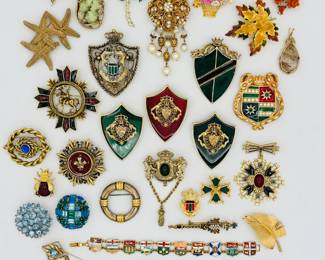 A fun selection of gold tone and enamel costume jewelry brooches pins and bracelet