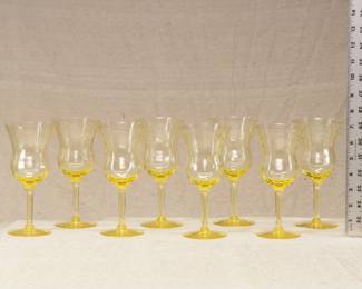 A set of eight yellow depression glass goblets with etched floral design