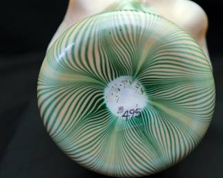 (Please note this photo includes an old price tag from when our client originally purchased the piece, and does not reflect the current sale price.) A beautiful antique pulled feather design art glass vase with flared ruffled rim, iridescent gold interior