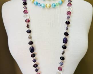 A Lisner pastel beaded choker necklace, a Lisner two-strand pastel beaded necklace, and an Etienne Aigner purple tone beaded and silver link necklace