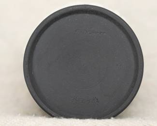 View of the base of one of the items from the group of five Wedgwood black jasper ware pieces including a vase and a lidded trinket box