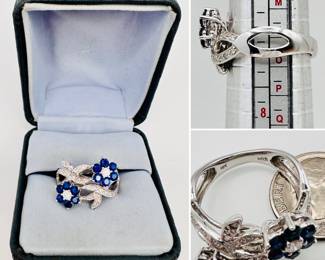 A lovely 18k white gold diamonds and sapphire ring, sapphires set in flower form encircled by diamond ribbons