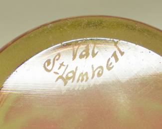 Closeup view of the 19th century Val St Lambert art glass vase, cased uranium glass, with a three-lobed rim; cranberry glass outer layer acid-etched to create a graceful seaweed decoration. Produced around 1897.