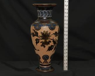A massive antique Royal Doulton Lambeth stoneware baluster vase, 18-1/2 inches tall. Decorated with a graceful spray of flowers over a swirl textured pale amber ground between a band of deep blue and brown lappets and roundels at the shoulder and points with roundels at the foot, a collar of white beaded overlapping blue roundels on the neck, two bands of white beading above the foot. Base shows impressed Doulton Lambeth mark, artist's marks, and model numbers. Late 19th century.