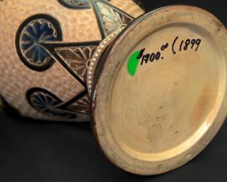 (Please note this photo includes an old price mark from when our client originally purchased the piece, and does not reflect the current sale price.) Closeup of the massive antique Royal Doulton Lambeth stoneware baluster vase, 18-1/2 inches tall. Decorated with a graceful spray of flowers over a textured pale amber ground between a band of deep blue and brown lappets and roundels at the shoulder and points with roundels at the foot, a collar of white beaded overlapping blue roundels on the neck, two bands of white beading above the foot. Base with impressed Doulton Lambeth mark, artist's marks, and model numbers. Late 19th century.
