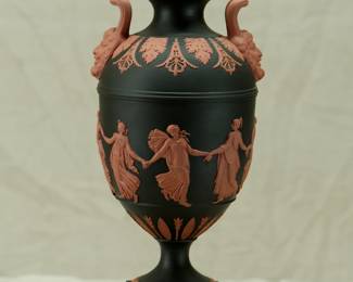 A marvelous Wedgwood black basalt 'Dancing Hours' lidded urn with applied terracotta relief and Bacchus head handles. Exquisitely fine modeling on this museum quality piece!
