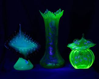 Seen under black light: Antique uranium glass jack in the pulpit vases and an antique Bohemian uranium green panel optic art glass vase with hand painted yellow enamel and gold scrolls