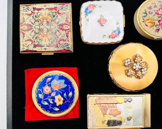 A collection of vintage powder compacts, and a vintage brass note holder with mechanical pencil notepad case with Japanese scene of geisha and Mount Fuji on the front cover, circa 1960s