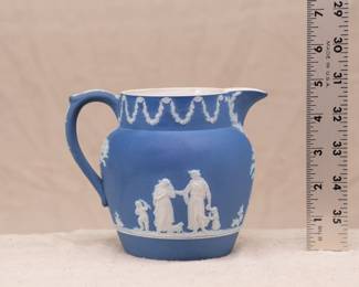 A small, Wedgwood, blue jasper dip pitcher or creamer, decorated with classical Greek figures and swag ornamentation