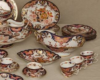 Another view of the group of 18th and 19th century Crown Derby Imari porcelain, including tea and cups and saucers, teapot, coffee cups, footed large serving platter/lazy Susan, lidded sauceboat with tray, plates, creamer, sugar, serving bowls and platters