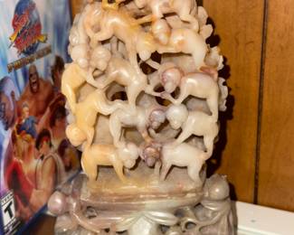 vintage Chinese carved stone statue depicting ten monkeys in an acrobatic pose