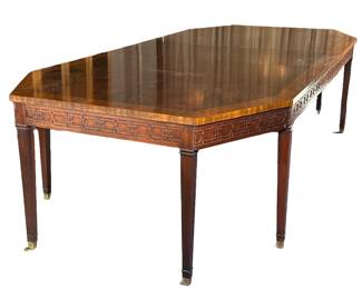 RALPH LAUREN / HENREDON CARVED WOOD DINING TABLE | Having burlwood veneer center with carved sides and brass casters; includes 2 22in leaves
Dimensions: h. 29 x w. 54 x l. 96 in (w/o leaves)