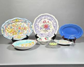 (7pc) Pottery | Two fish dishes one large and one small, small bowl with cherries, small trinket polka dot bowl, two oblong dishes in shades of blue, and lilac trimmed dish surrounding rose colored flowers. All signed or marked. - dia. 11 in (Lilac/floral plate)