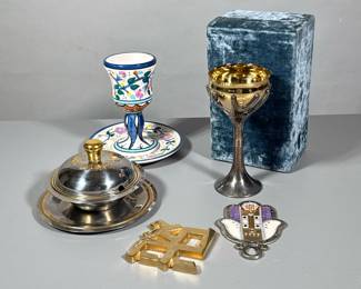 (5pc) MIXED JUDAICA | Including: Rosenthal Silverplate “Tree of Life” kiddish cup, The Jacob Rosenthal Judaica Collection ceramic kiddish cup, Inox honey pot, decorative hamsa, and gold plate decoration - h. 4 x w. 5 x l. 8.25 in