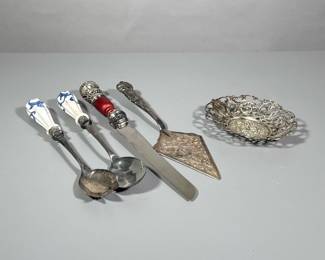 (6pc) Miscellaneous Silver | Salad serving pieces with porcelain handles, large sterling and wood handled challah knife marked 925, Cartier spatula, silver soap dish/small tray, and crystal bell with silver handle.
- l. 14 in (Challah Knife)