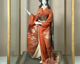 Geisha Doll | Porcelain statue with traditional kimono attire and wig in display case. Possibly a Nishi Doll, 18” tall. - h. 25 x w. 16 x d. 14 in