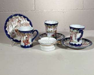 (8pc) Japanese Tea Cups | Blue rimmed cups and saucers with geisha girls. Tea strainer marked Japan.
Dimensions: h. 3 x dia. 2.5 in (Tea cup)