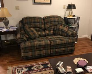 Plaid double recliner/rocker loveseat Southwest print rug.