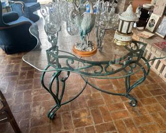 Large scrolled glass top table with an iron base. Could be a dining table or a center table - very heavy