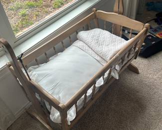 Cradle with vintage bed linens