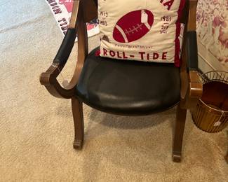 Pillow is handmade and vintage chair is upholstered in black leather-like material