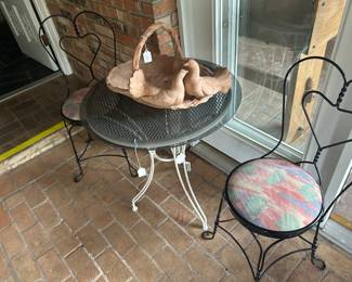 Cafe style table and chairs. Basket is terracotta.