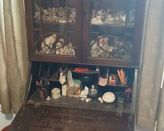 Folding armoire with display case and shelves.
