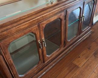 Asian lighted curio console.