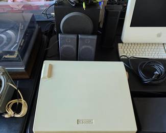 Vintage typewriter, computer speakers with subwoofer