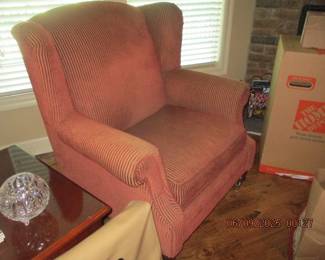 One of two matching stuffed wing-back chairs