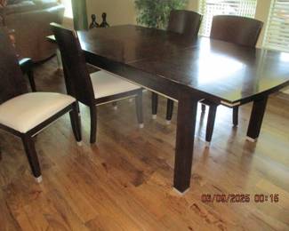 Dining table with four chairs and one leaf