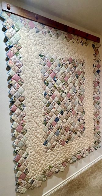 Lovely quilt on quilt wall mounted hanger. Quilt and hander are being sold separately. This particular quilt is not handmade.