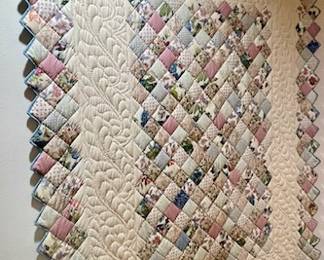 Lovely quilt on quilt wall mounted hanger. Quilt and hander are being sold separately. This particular quilt is not handmade.