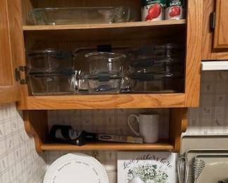 Kitchen Aid hand mixer, mixing bowls, bakeware, cookie tray with cookie tongs, Pyrex and more. We've check the dates on all the canned items, they are still good per date on items. Using them more for display purposes, but if you're game to buy.....