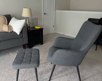 Modern gray upholstered chair with matching ottoman