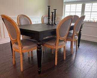 Eight dining chairs and extended black dining room table